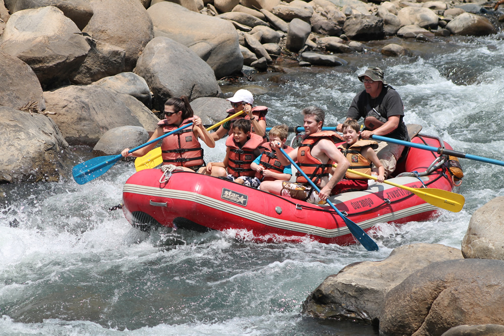 a man in a red raft in the water