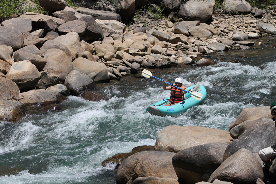 A woman on an inflatable kayak tour in Durango