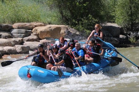 group of rafters going down a rapid