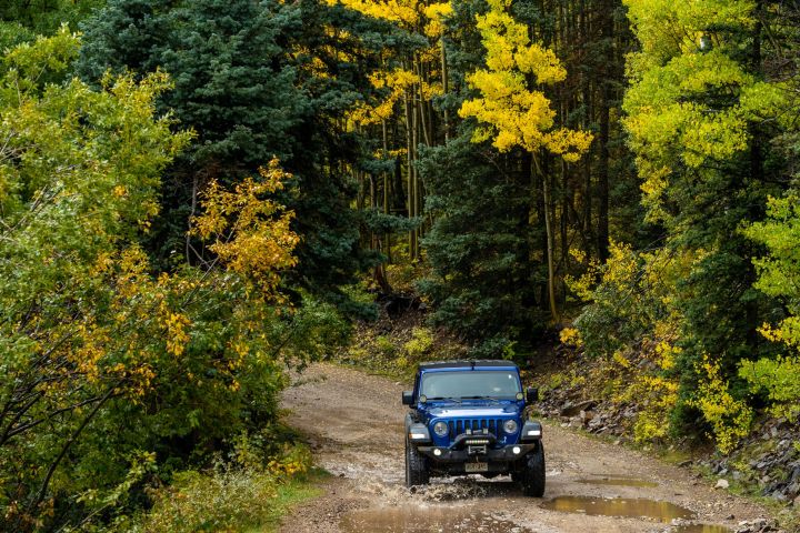 a truck driving down a dirt road