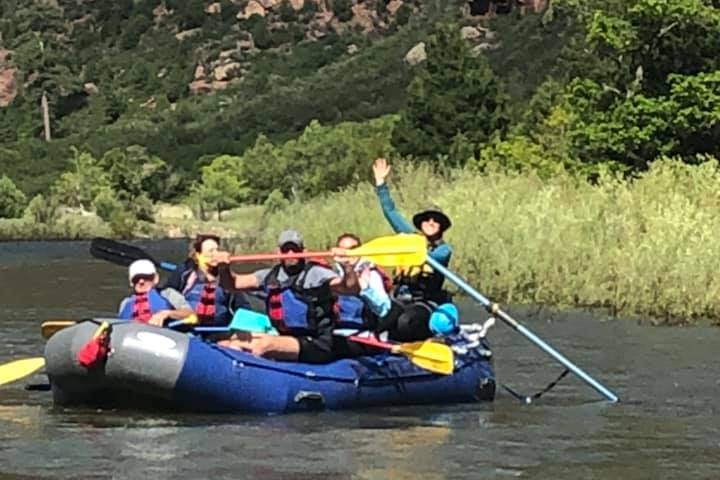 a group of people on a raft in a body of water