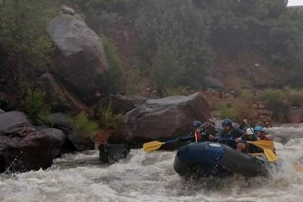 a group of people on a raft in a body of water