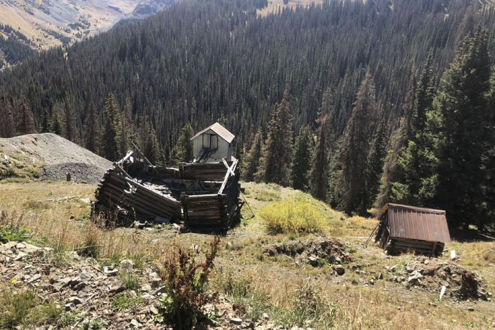 a man standing in front of a mountain