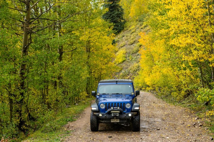 a truck driving down a dirt road