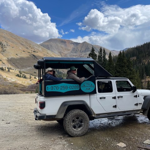 a truck is parked on the side of a mountain