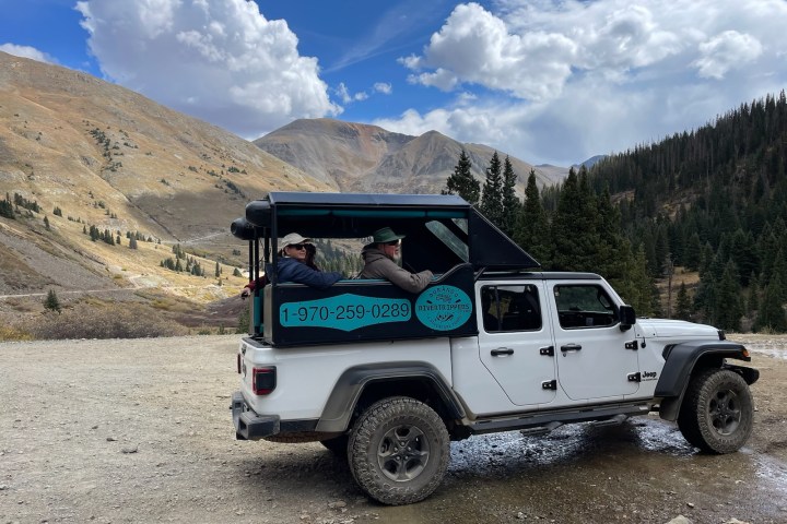 a truck is parked on the side of a mountain