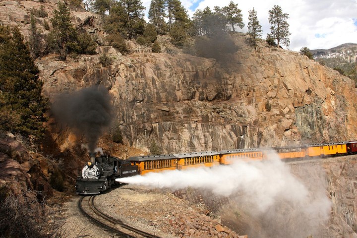historic train riding along rocky mountains