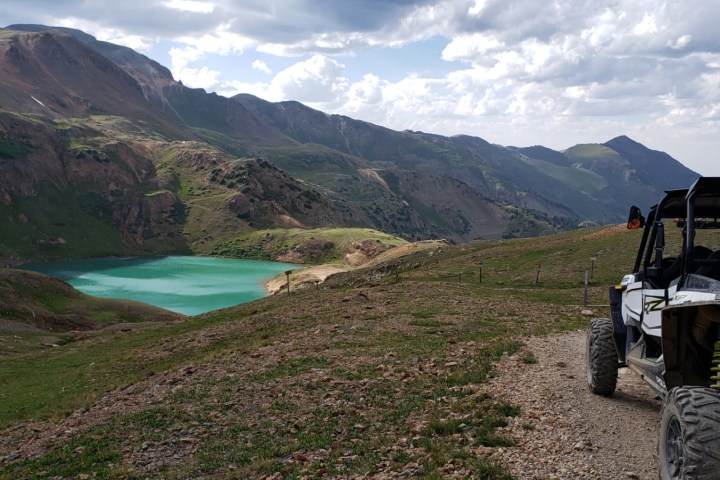 a truck is parked on the side of a mountain