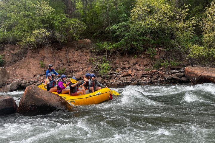 a group of people on a raft in a body of water