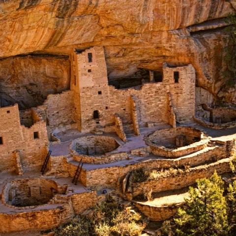 a close up of a stone wall with Mesa Verde National Park in the background