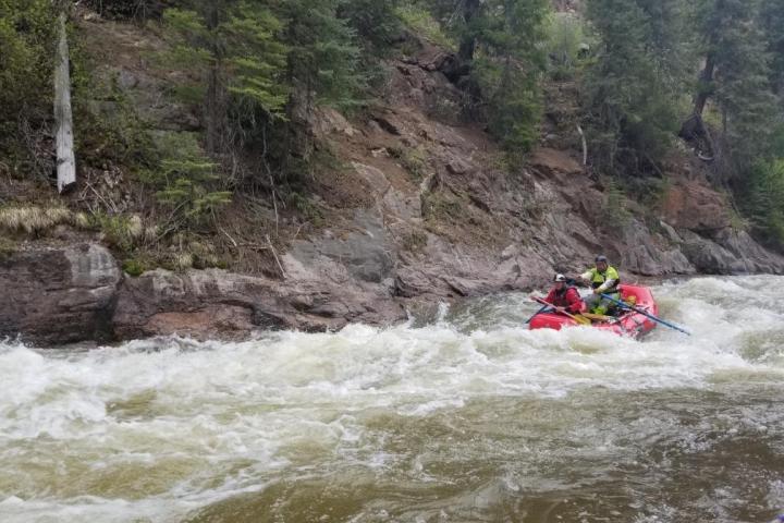 a man riding on a raft in a body of water
