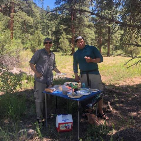 a group of people standing next to a tree