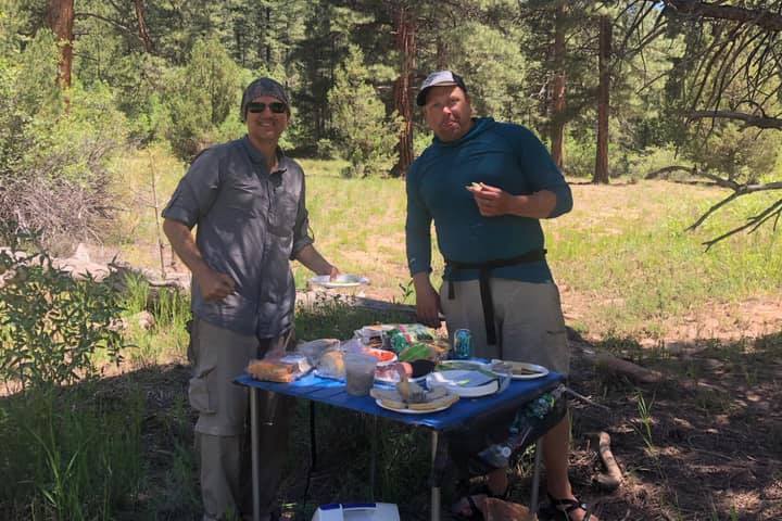 a group of people standing next to a tree