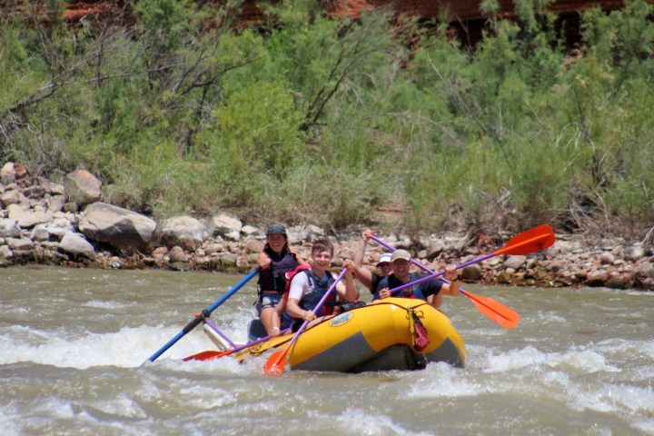 a group of people riding on a raft in a body of water