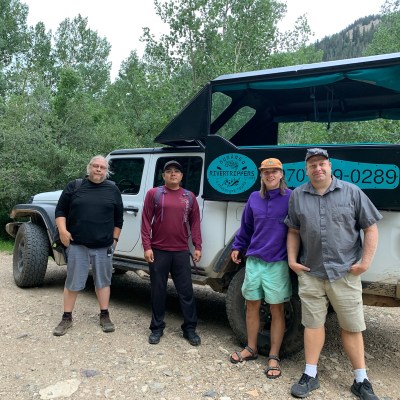 a group of people standing in front of a truck