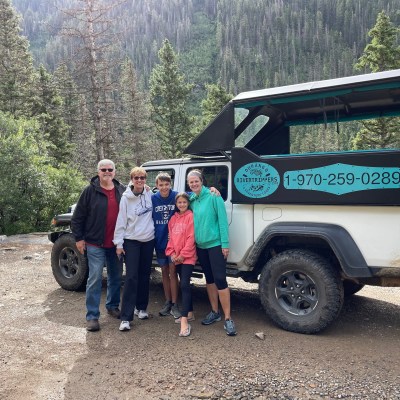 a group of people standing in front of a truck